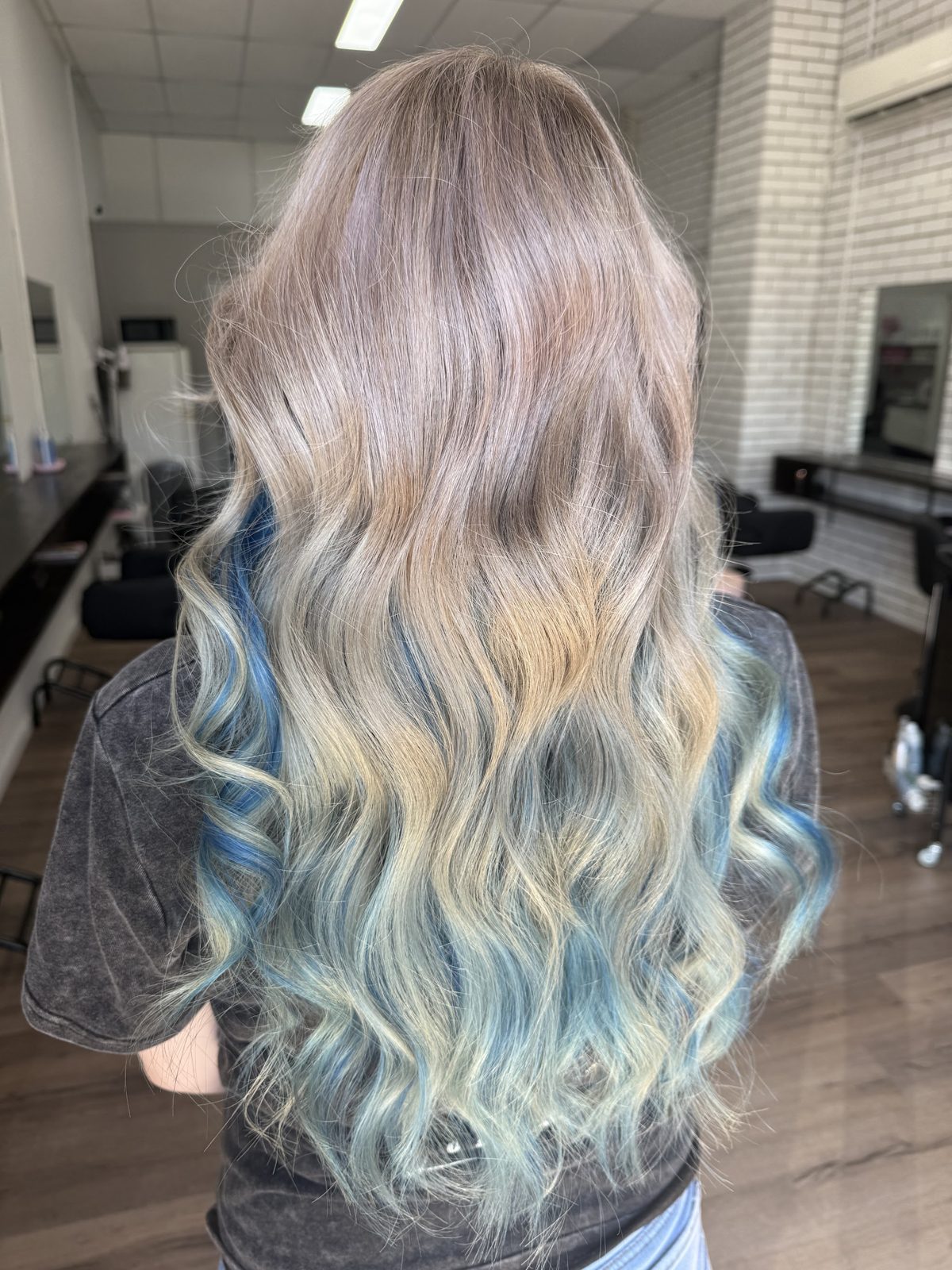Long blonde balayage with blue and teal ends