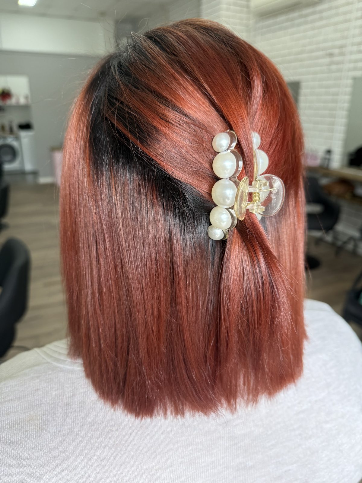 Copper red colour with a dark root and pearl hair clip