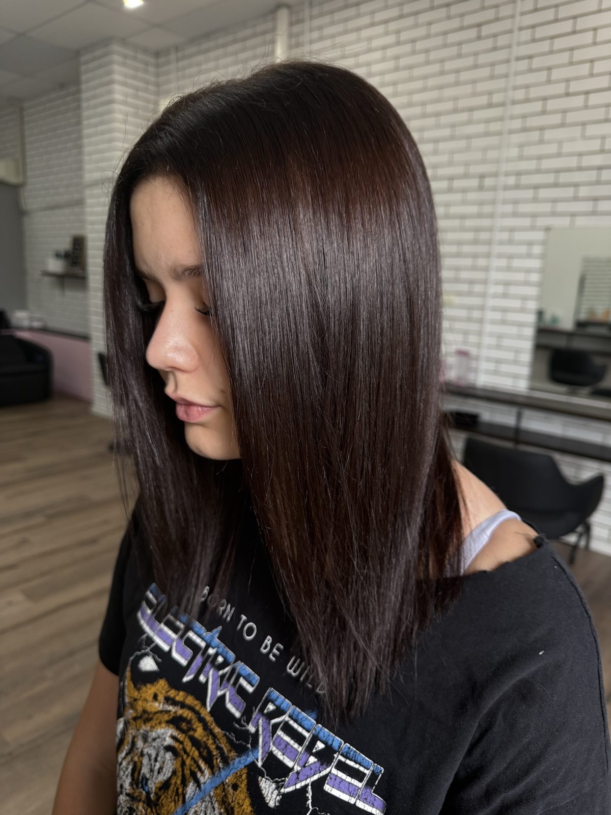 Glossy dark brunette hair in side profile